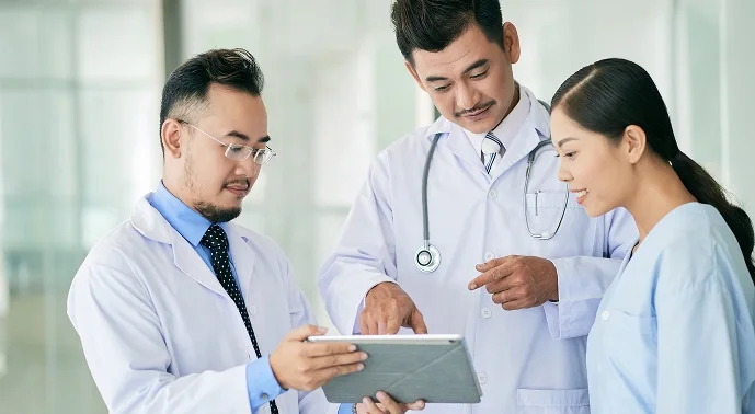 Pharmacovigilance experts reviewing safety data together